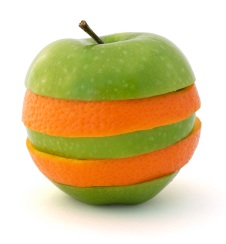 Sliced apple and orange merged together on a isolated white background.